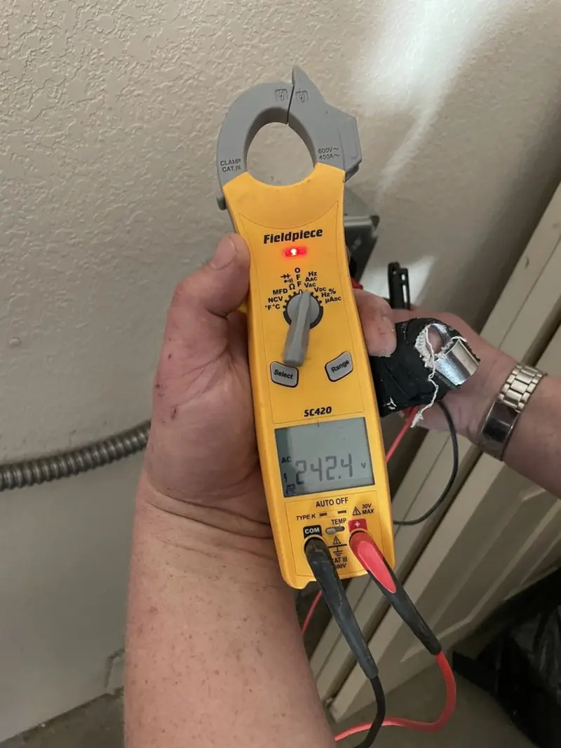 Voltage testing with clamp meter during Outlet Installation in Wales
